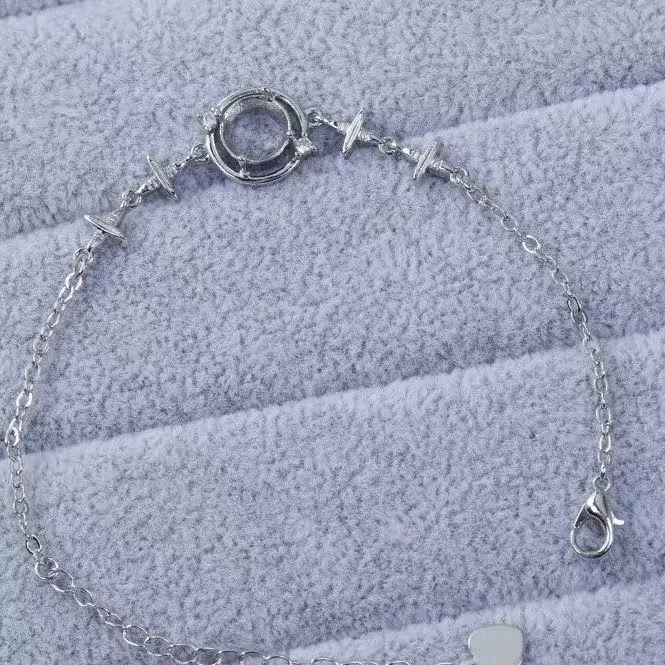 Delicate circular keepsake bracelet on textured fabric
